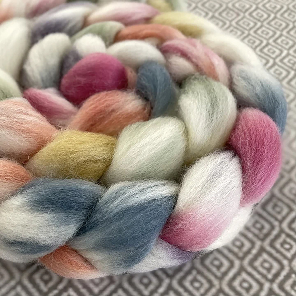 Detail of Greenwood Fiberworks Pigtails Diamond in white and pastel blue, pink, yellow, orange, and green colors
