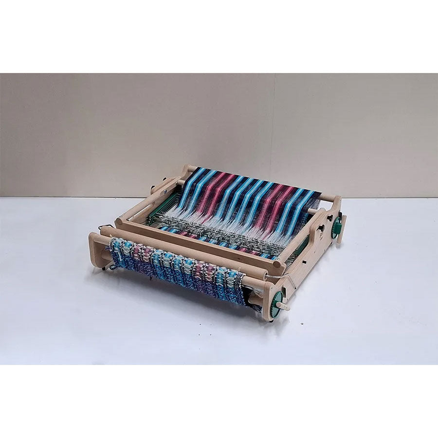 Wooden Lojan Flex loom with a colorful weaving project shown in its folded state