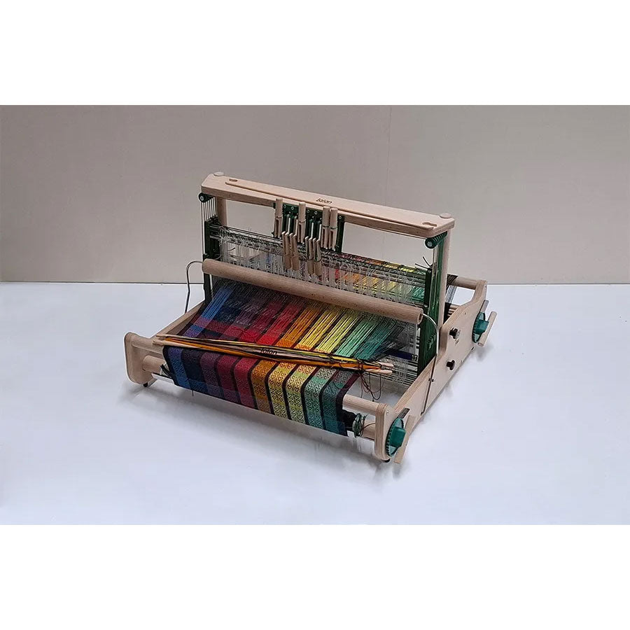 Wooden Lojan Flex loom with a colorful weaving project on a white background 