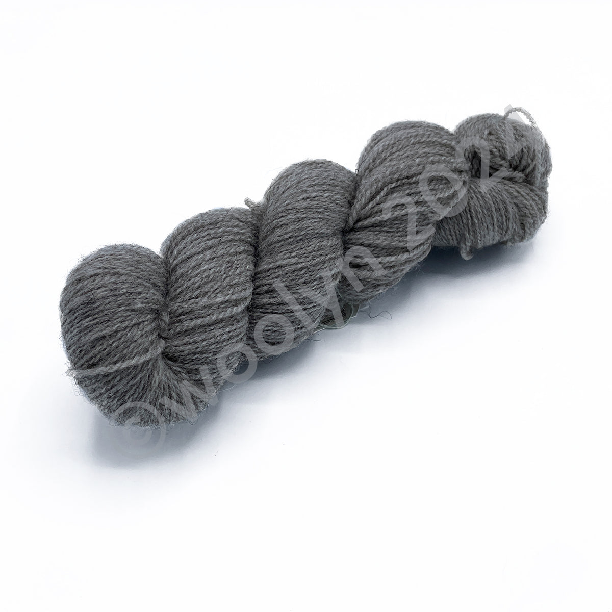 A skein of Woolerton Estates Farmhand Gwendolyn, an ondyed light grey color.