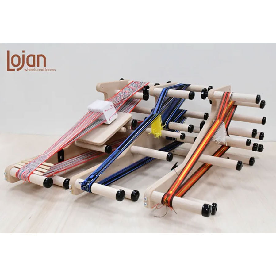 Three wooden inkle looms in a line all with different colorful weaving projects on them 