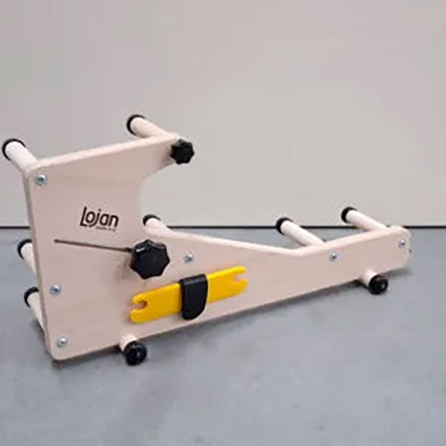 Side view of the wooden Lojan inklette loom showcasing the shuttle and shuttle attachment to the loom