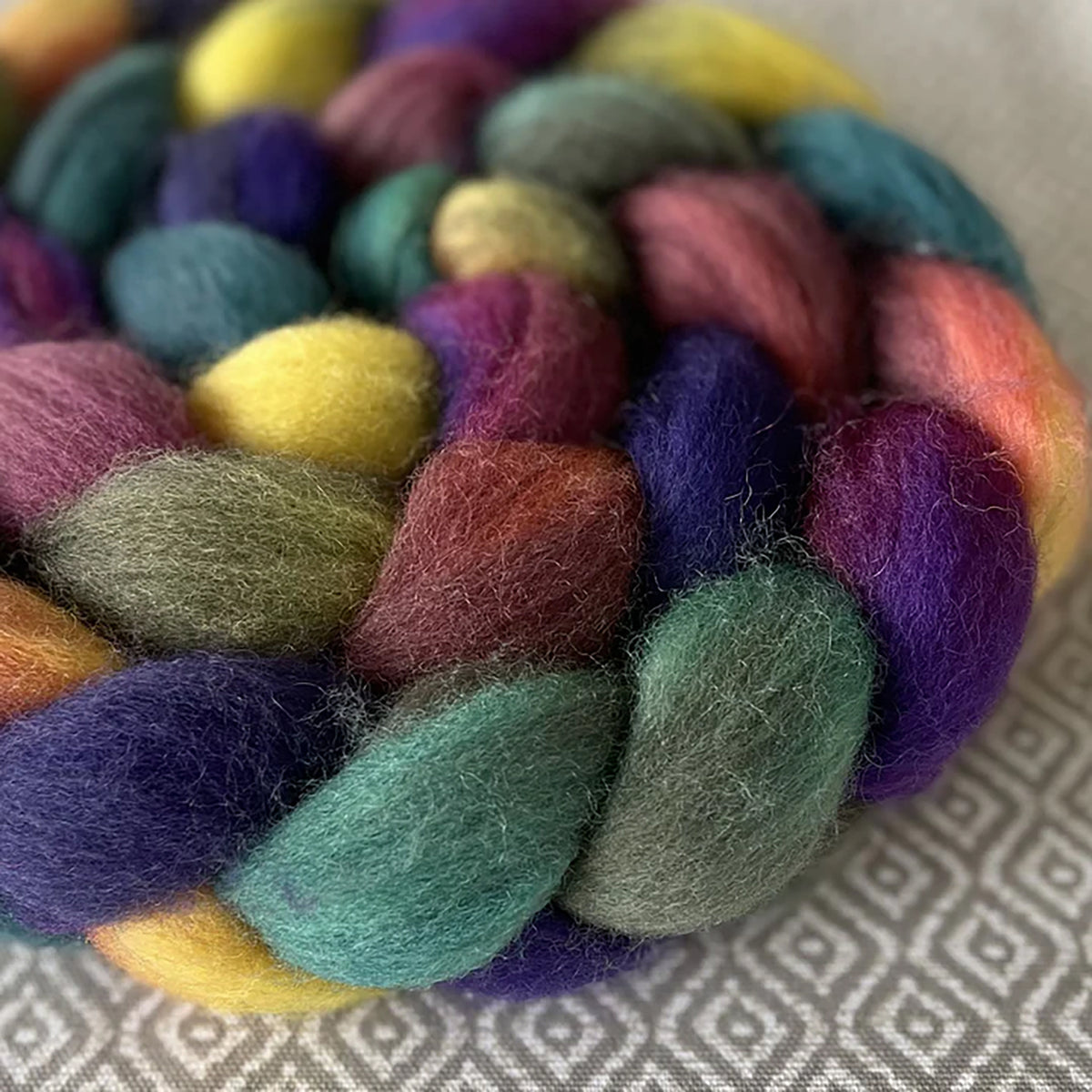 Detail of Greenwood Fiberworks Pigtails Opal in colors Royal purple, teal, dusty pink, yellow, and earthy green