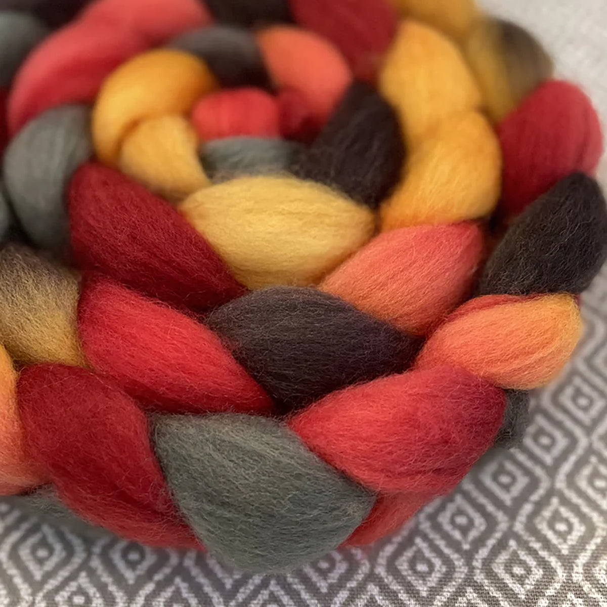 Detail of Greenwood Fiberworks Pigtails Sunflower in earthy yellows, reds, brown, and grey colors