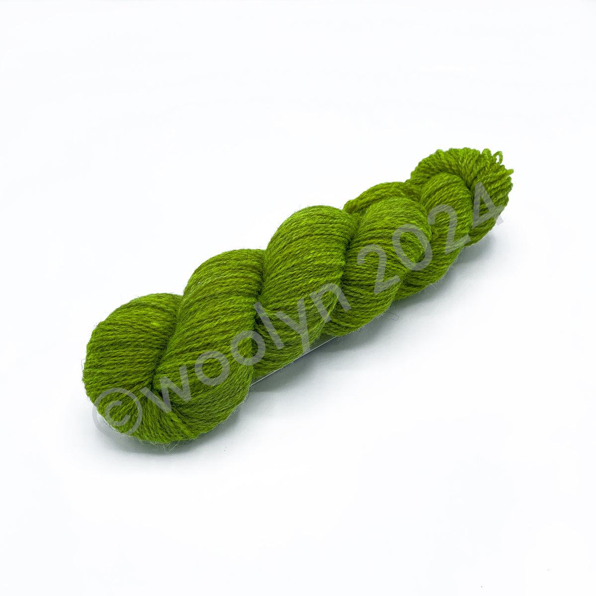 A skein of Woolerton Estates Farmhand Tabitha, a bold lime green color.