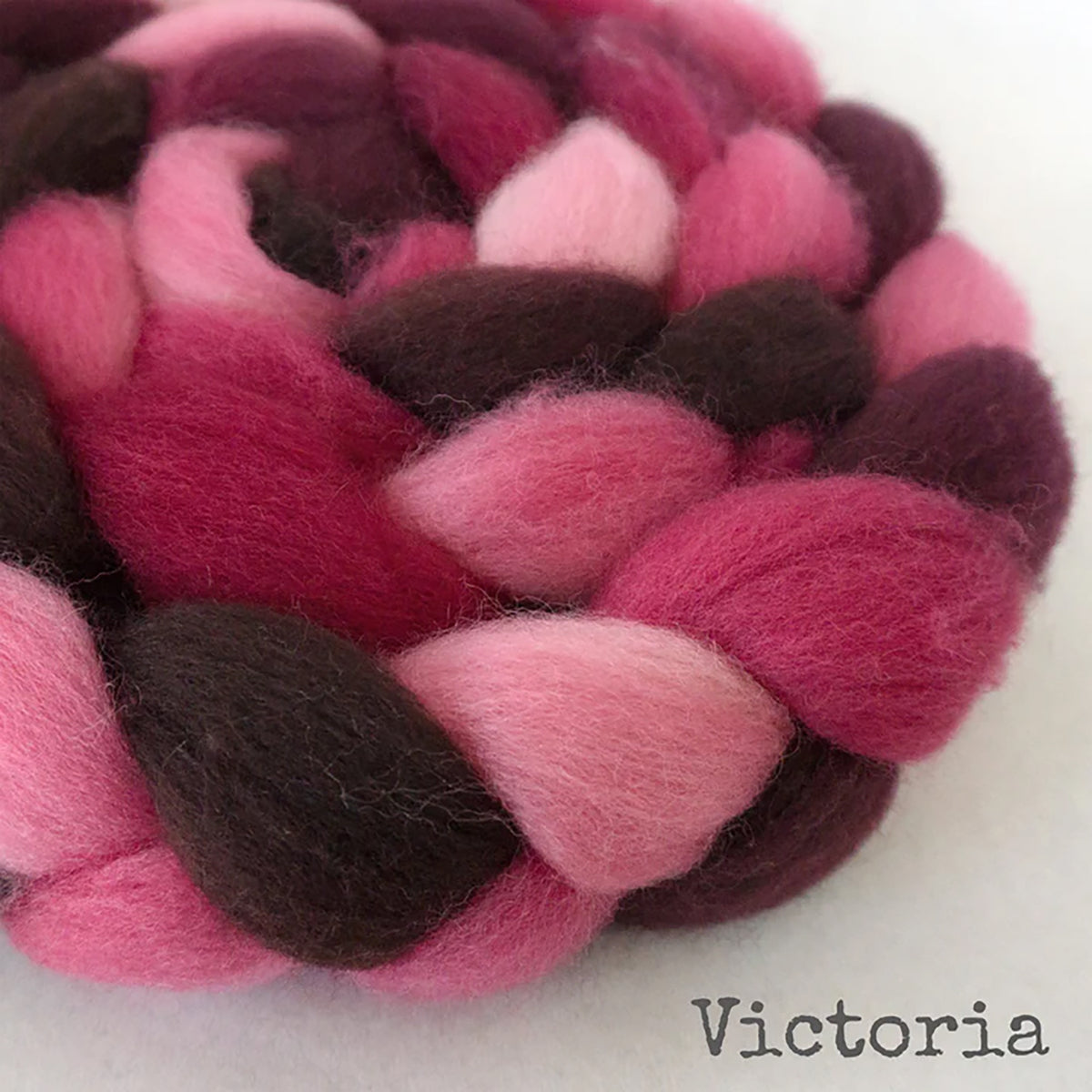 Detail of Greenwood Fiberworks Pigtails in Victoria, light pink, dark pink, and brown colors
