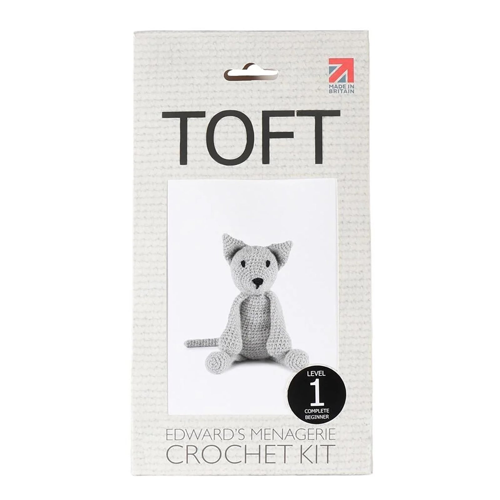 Toft Crochet Kit for Alexandre the cat, a light grey color. Level 1 difficulty. Kit contains instruction booklet, crochet hook, yarn, stuffing, and tapestry needle.