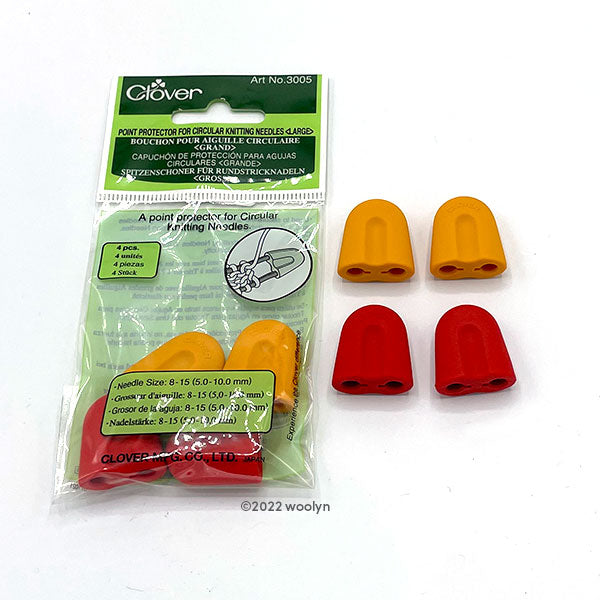 A package of 4 large circular point protectors, two yellow and two red