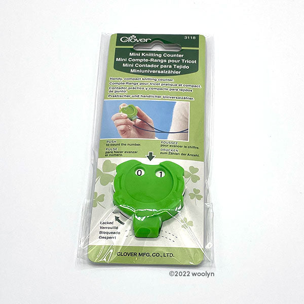 Clover Mini Kacha Kacha row counter in lime green with white button on top, white dials on the sides, and a loop on the bottom to attach a cord.