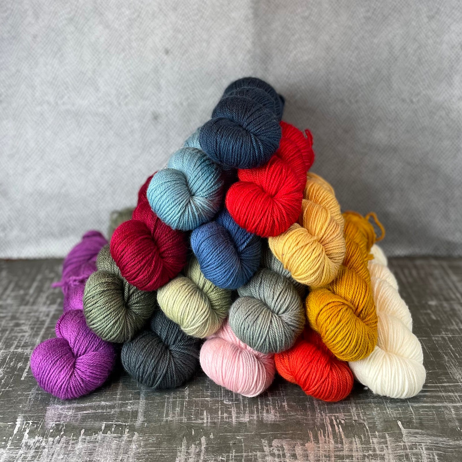 Skeins of Tesserae Chaton in different colors stacked in a pyramid shape