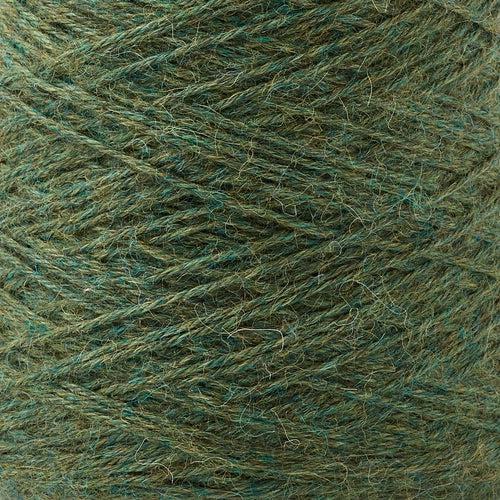 Detail of Gist Yarn Ode Basil, a heathered dark green with flecks of teal and yellow.