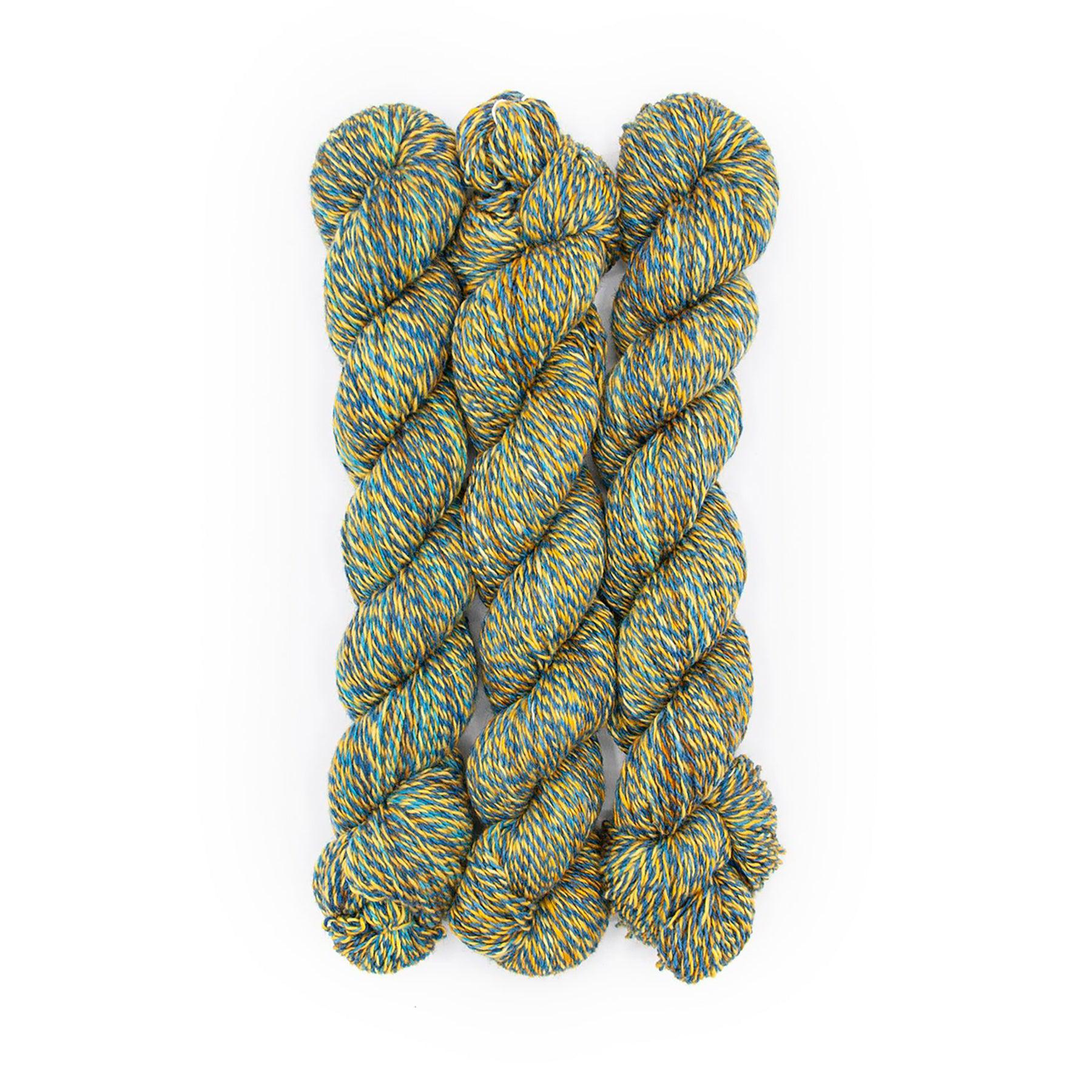 Plied Yarn North Ave Arch Social Club a marled yarn with turquoise, mustard and brown colors.