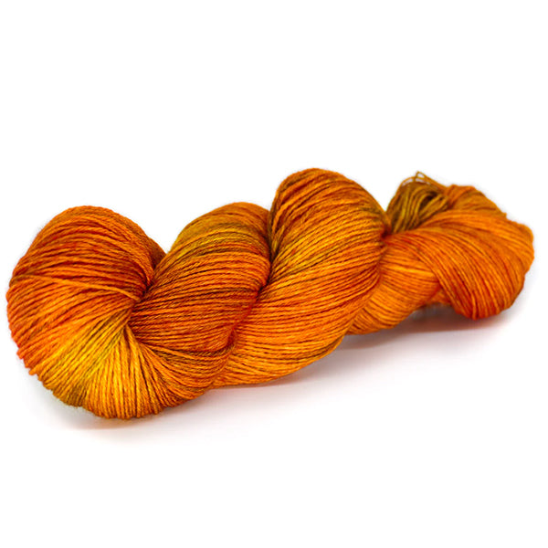 A skein of Laneras Deseos Autumn Perfection, variegated orange and yellow with hints of green