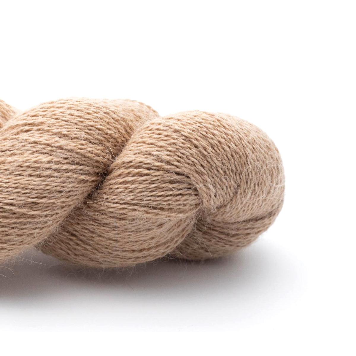 A skein of Kremke Baby Alpaca Lace Camel in sandy brown 