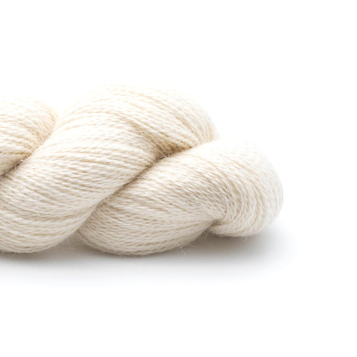 A skein of Kremke Baby Alpaca Lace Natural in off-white 