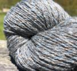 Detail of North Light Fibers Seaside Black Rock Cove, a marled yarn in grey, warm brown and blueish grey.