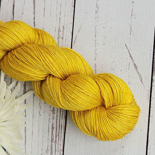 Yarn Love Amy March in Candied Lemon a medium yellow yarn.