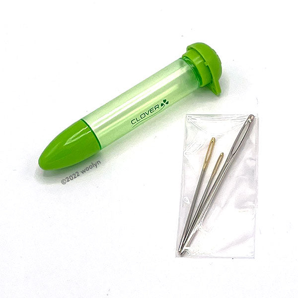 Chibi needle case in green and three tapestry needles in various sizes.