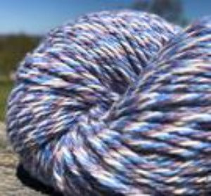 Detail of North Light Fibers Seaside Cormorant Cove, a marled yarn in cream, cornflower blue and plum.