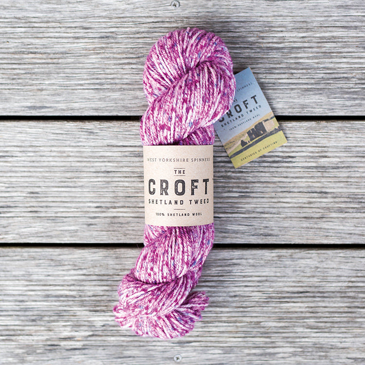 West Yorkshire Spinners the Croft Shetland Tweed in Dalsetter a white yarn with purple and magenta speckle.