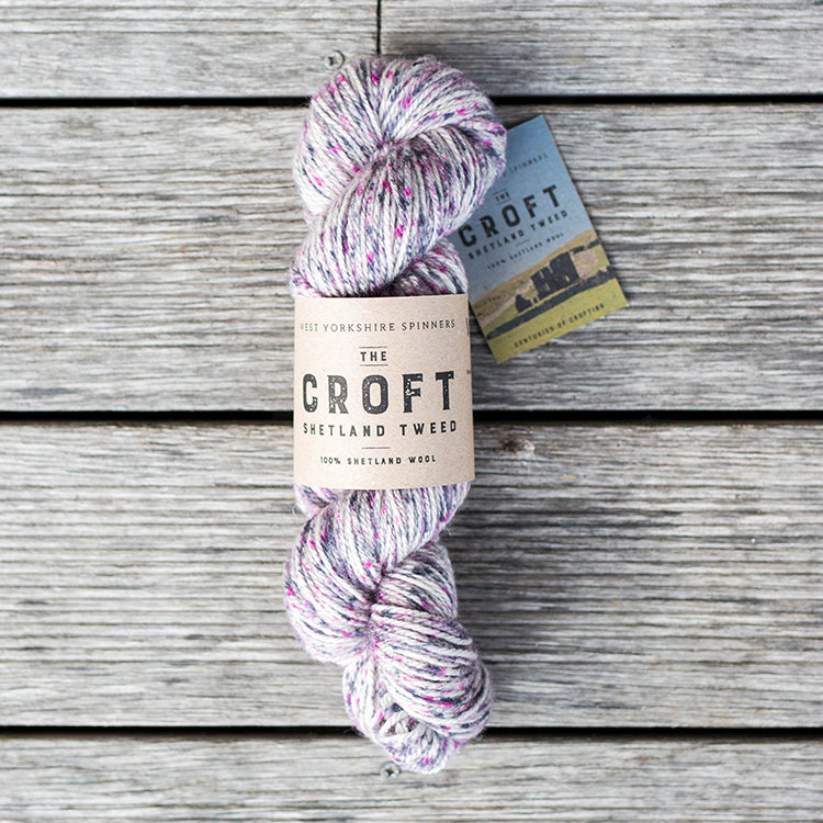 West Yorkshire Spinners the Croft Shetland Tweed in Maryfield a white base yarn with grey and magenta speckle.
