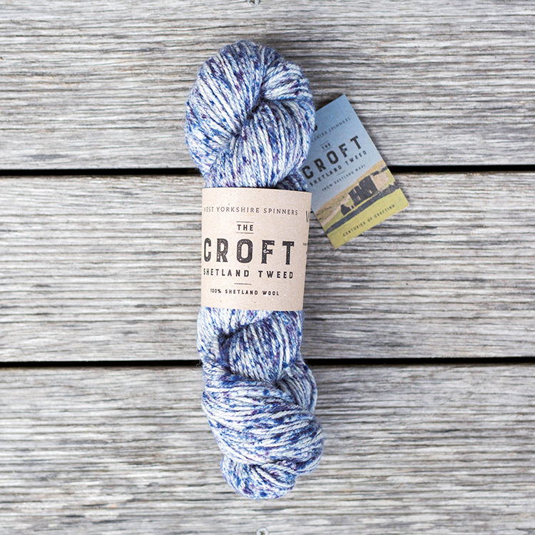 West Yorkshire Spinners the Croft Shetland Tweed in Boddam a white yarn with multi-blue speckle. 