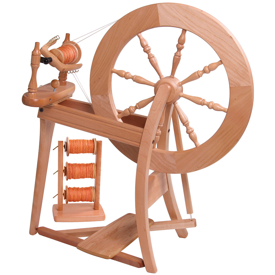 Front view of the Ashford Traditional Spinning wheel with a lazy kate in the background.