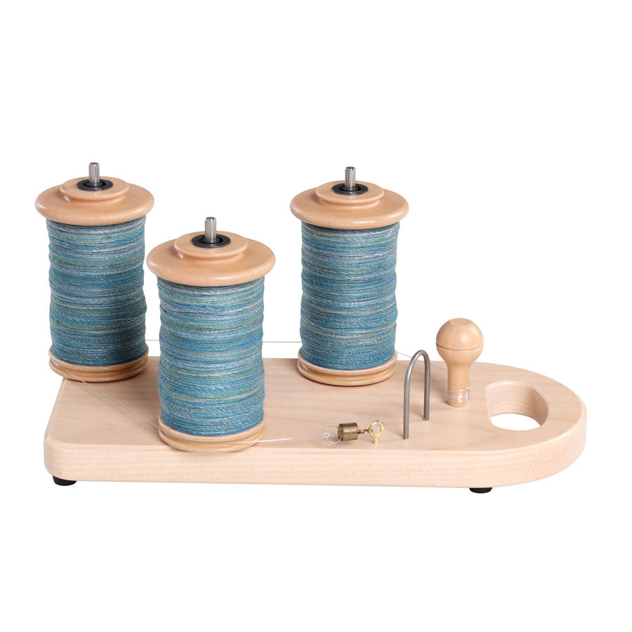 Ashford tensioned lazy kate. Shown with three full bobbins.