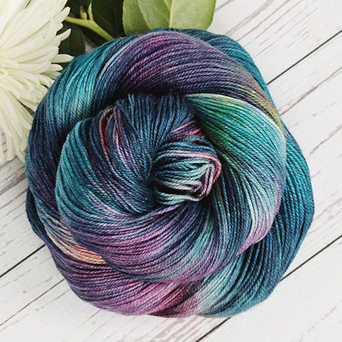 Yarn Love Amy March in Final Frontier a variegated yarn in turquoise, teal, and purple.