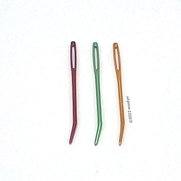3 darning needles in a variety of colors (red, green and gold) for weaving in ends. 