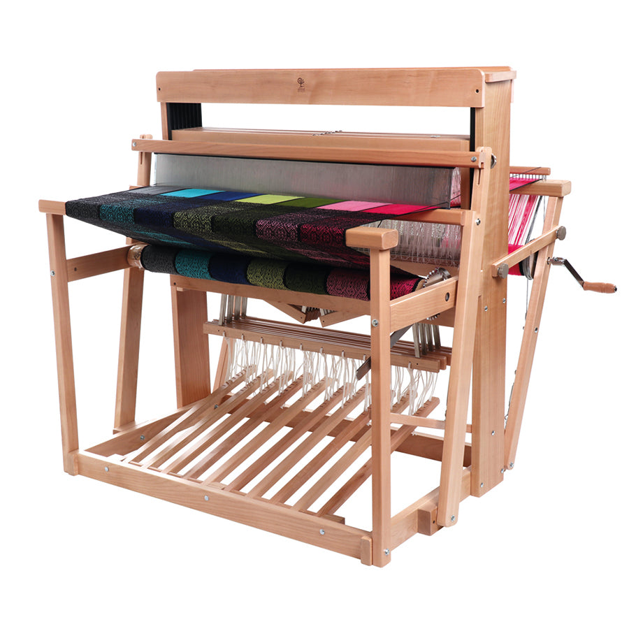 Front view of the Ashford 8 Shaft Floor loom.  Shown with a brightly colored warp in rainbow stripes. 