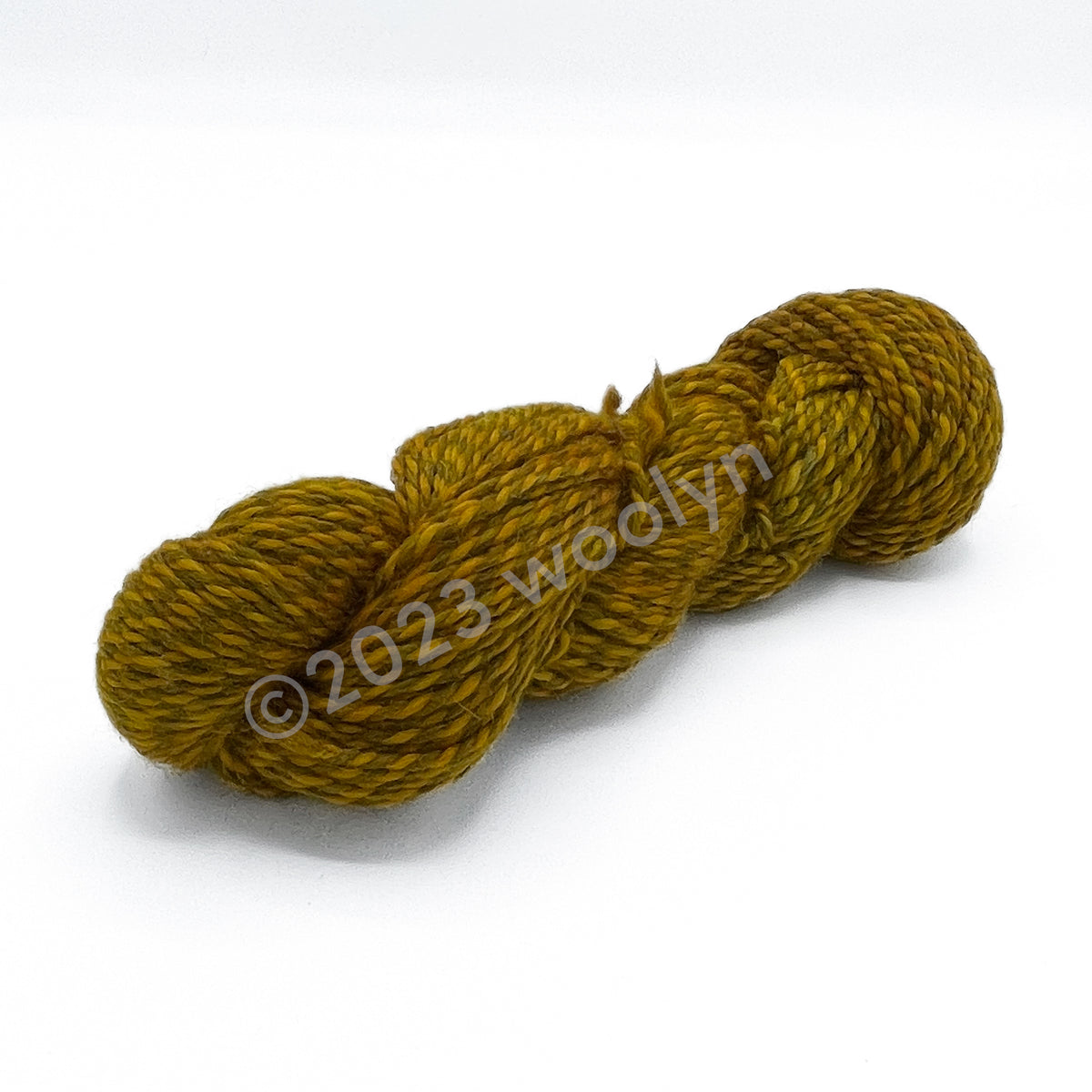 A skein of Tesserae Chonky in Ketchup And, a bright yellow plied with a darker greyish yellow
