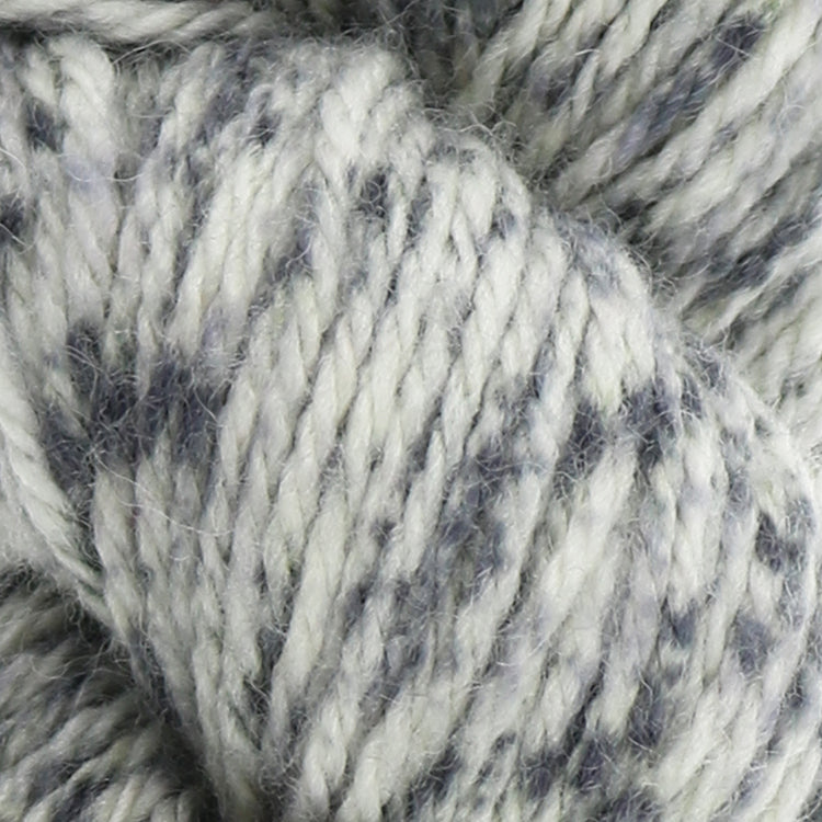 West Yorkshire Spinners the Croft Shetland Tweed in Lunna a white base yarn with grey speckle.