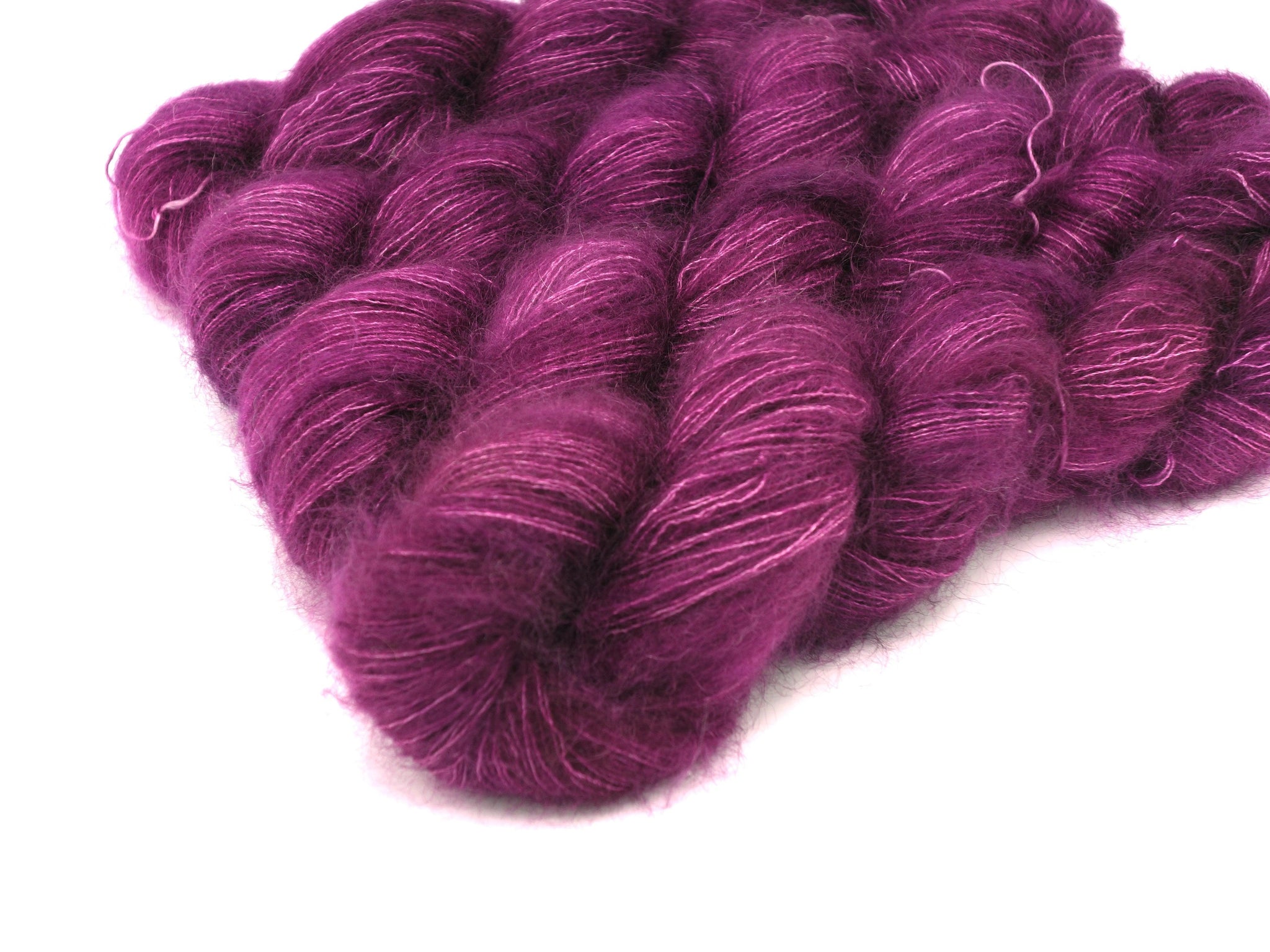 Skeins of Murky Depths Mirage Lucia, a bright jammy tonally variegated purple. 