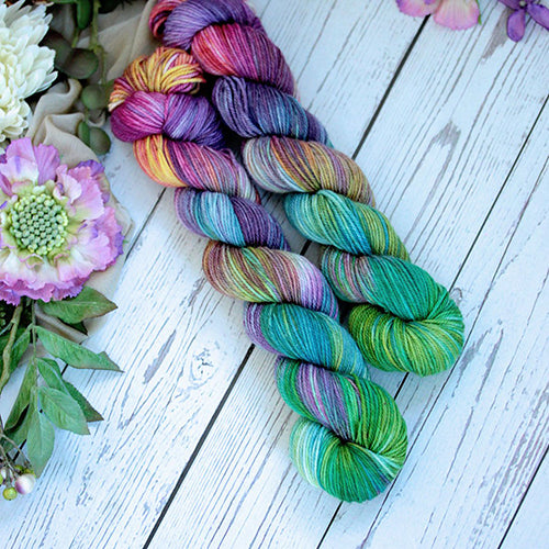 Yarn Love Amy March in Stained Glass a variegated yarn in a subtle rainbow of colors. .