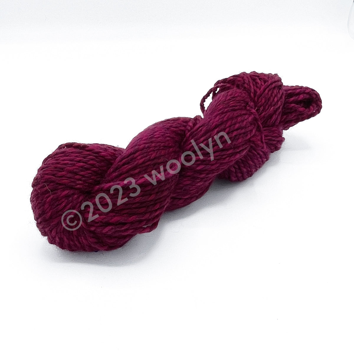 A skein of Tesserae Chonky in Yeah No Yeah, a hot pink plied with magenta