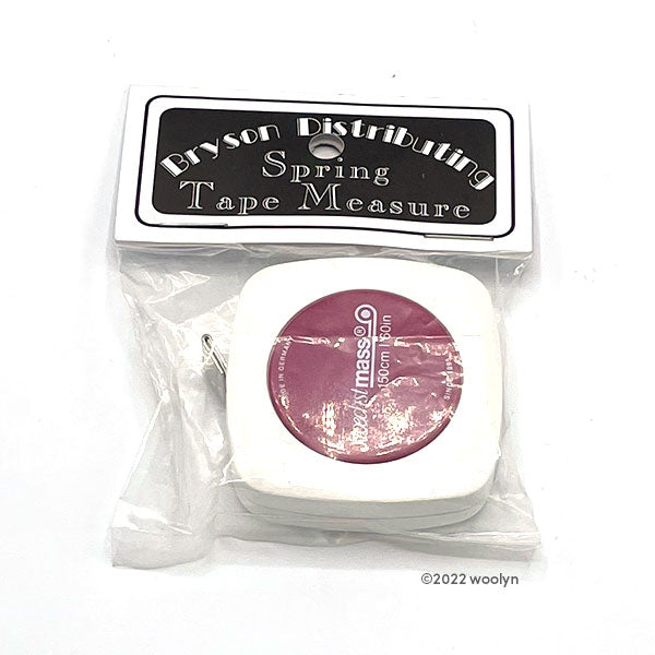 White and pink retractable tape measure in a package. 