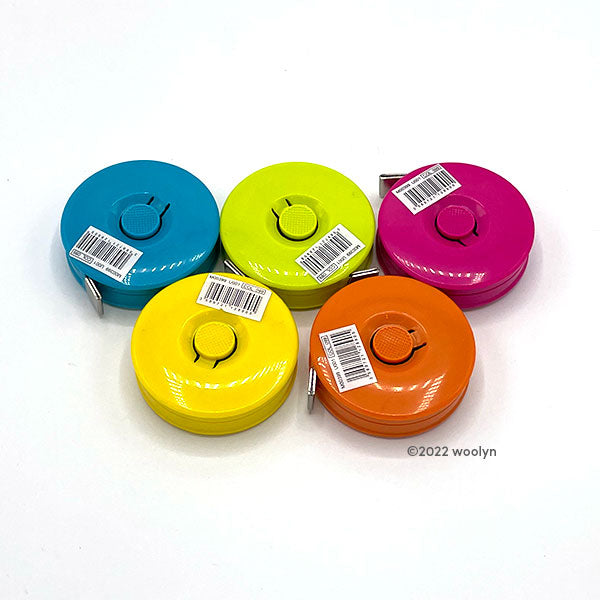 Colorful tape measures in teal, lime green, magenta, bright yellow and orange. 