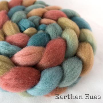 Detail of Greenwood Fiberworks Pigtails Earthen Hues in pale blue, green, yellow, pink and red.