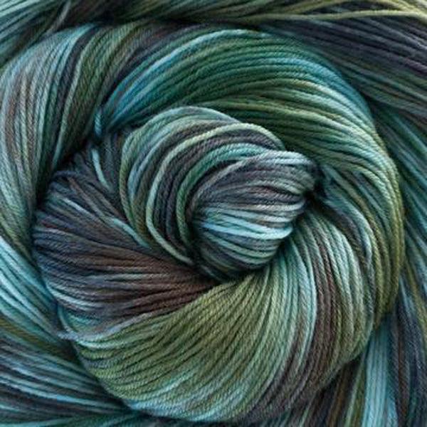 Detail of Greenwood Fiberworks Simply Sock Tribe, a variegated yarn with sage green, chocolate brown and light blue.
