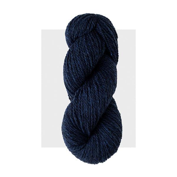 Skein of Harrisville Highland Midnight Blue, a very dark blue heathered with slightly lighter blue.