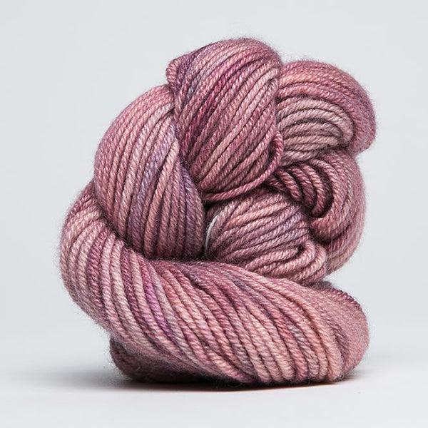 Skein of Jade Sapphire Cashmere 8Ply Pink Granite 205, a gently variegated tonal pink with hints of grey. 