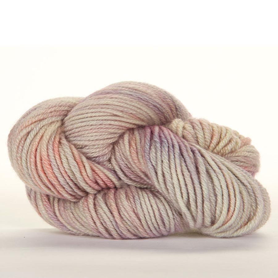 Skein of Jade Sapphire Cashmere 8Ply Pudding + Pie 206, a gently variegated yarn in shades of ivory, light pink and pale purple. 