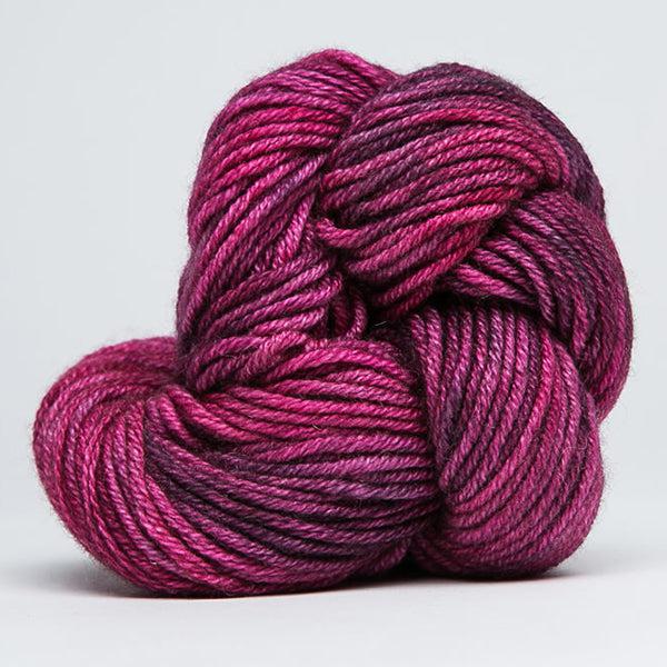 Skein of Jade Sapphire Cashmere 8Ply Triberrytops 173, a tonally variegated yarn in raspberry and shades of purple.