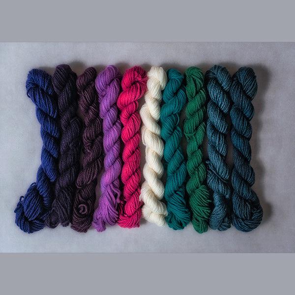 10 mini skeins of Jade Sapphire Coloring Box Bridget's Delight- and pattern booklet in shades of purple, green, teal, pink and natural.