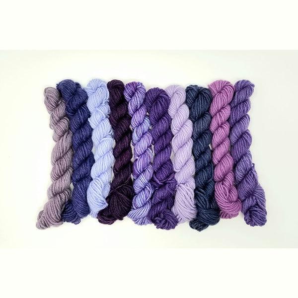 10 mini skeins of Jade Sapphire Coloring Box emPOWER Purple-and pattern booklet shades of purple.