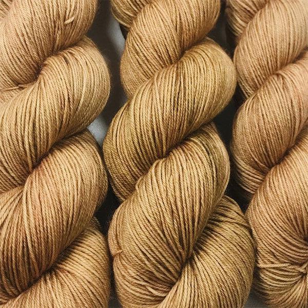 Skeins of JEMS Monster Minis Mud Pie, a warm light brown.