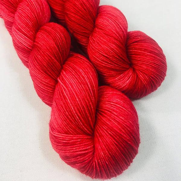 Skeins of JEMS Monster Minis Ruby Red, a bright tonal red.