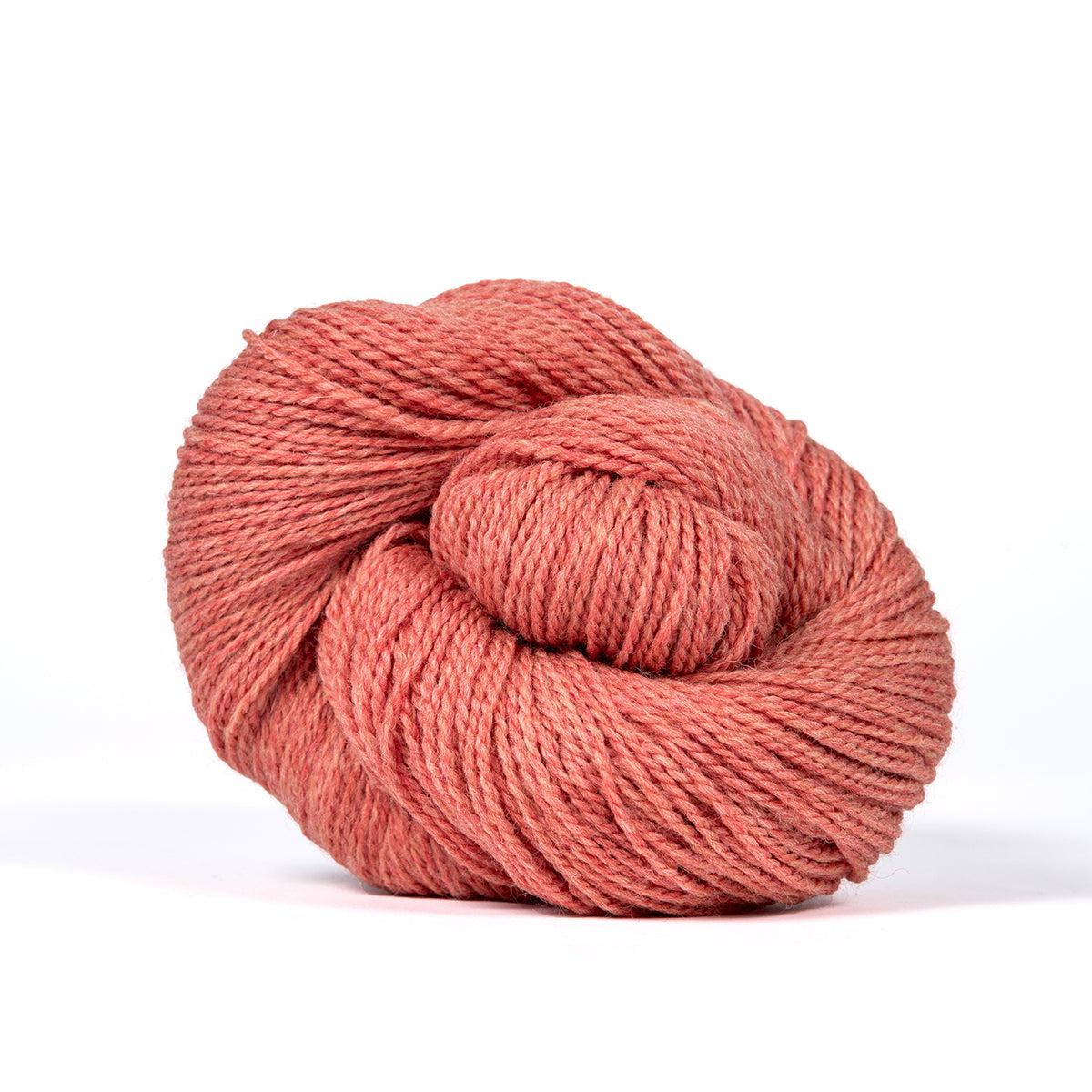 A skein of Kelbourne Woolens Camper Coral Heather 667, a heathered melon pink.