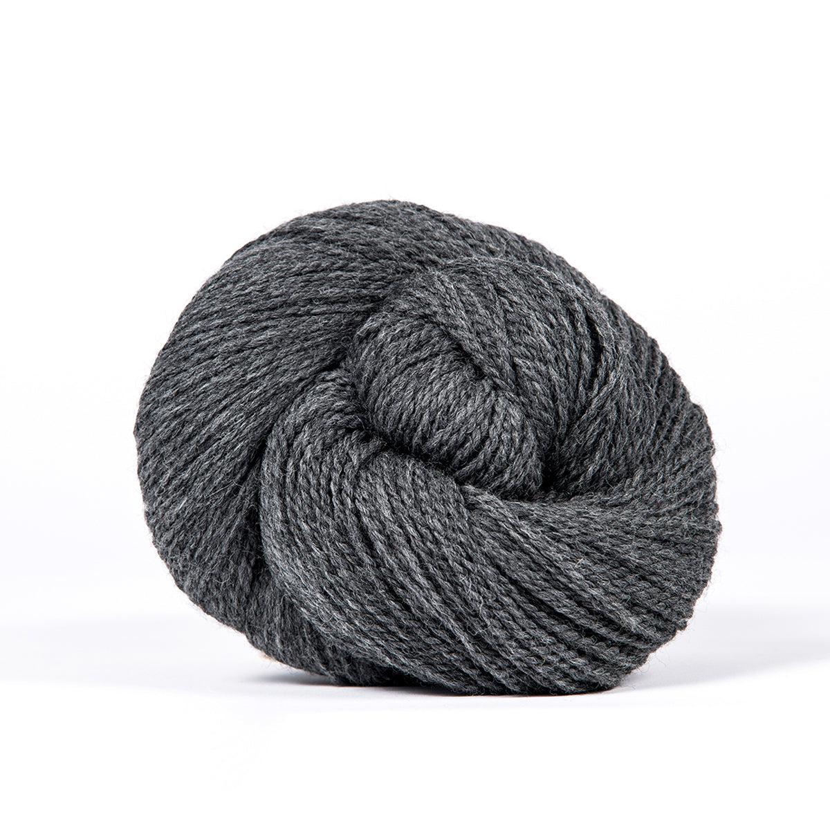 A skein of Kelbourne Woolens Camper Graphite Heather 034, a heathered medium grey.
